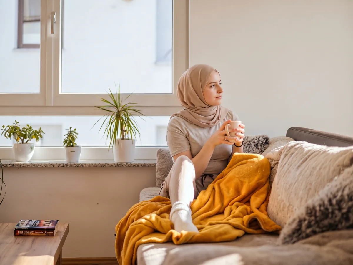 A woman relaxing at home in dry, heated indoor air