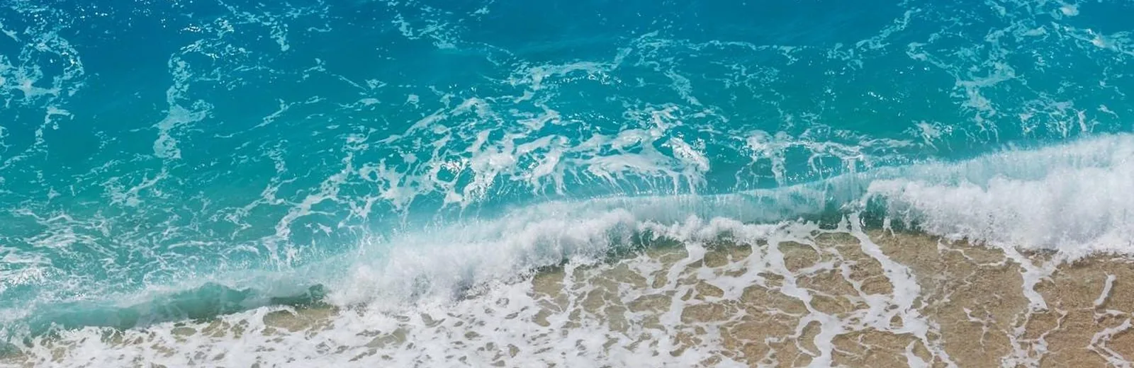 Turquoise sea meeting soft sand